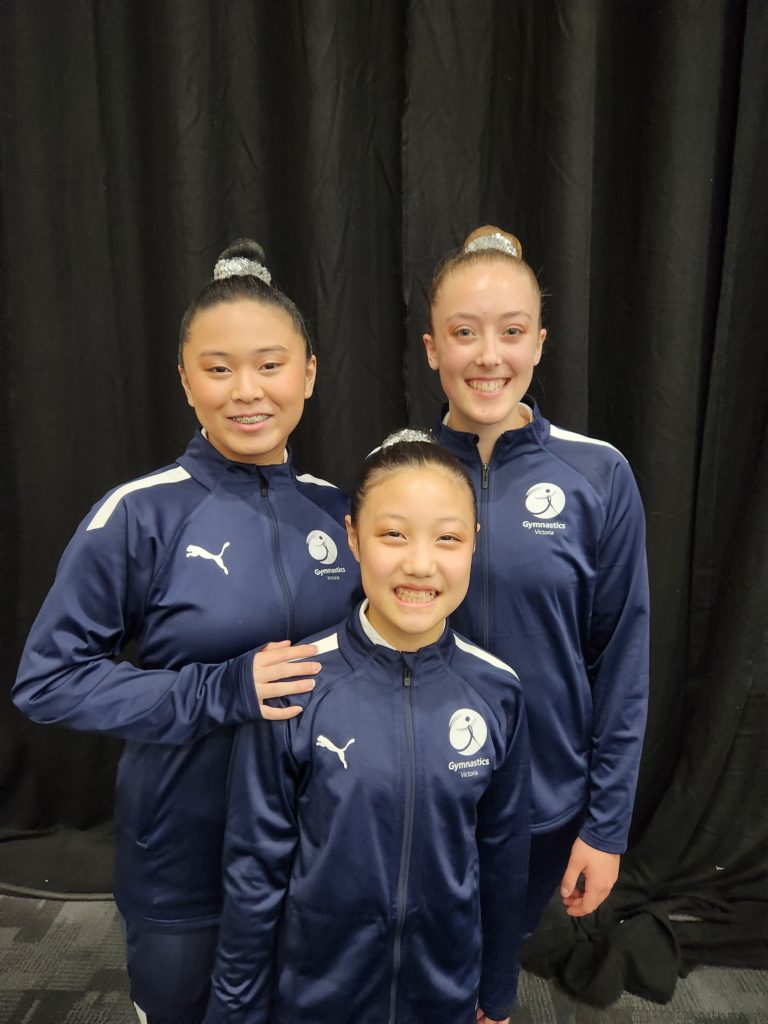 Trio of acrobats in State team uniform tracksuits