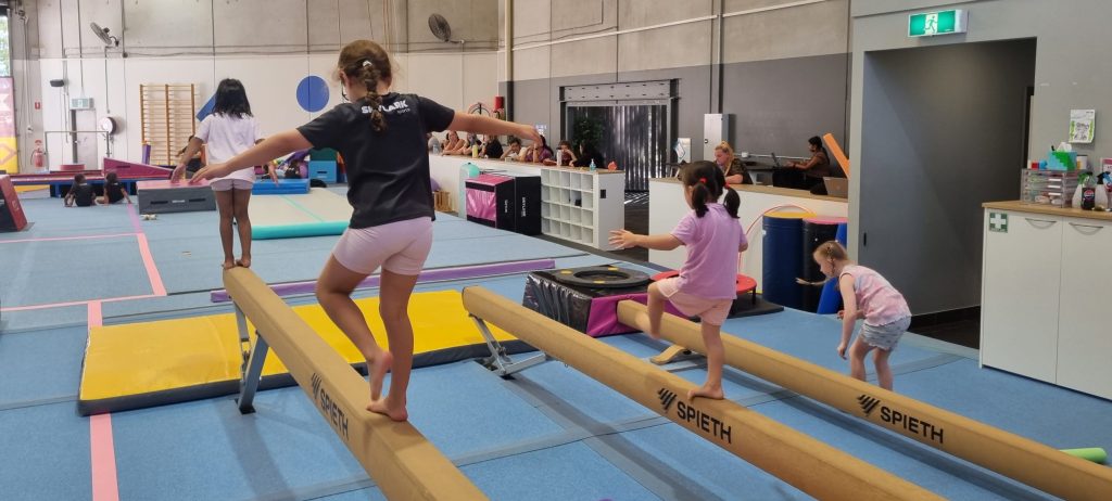 gymnastics class walking on balance beams