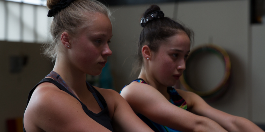 Gymnasts in uniform training