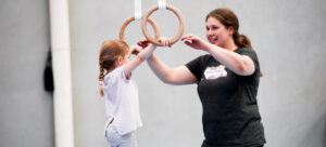 Child having fun in KinderGym with qualified coach