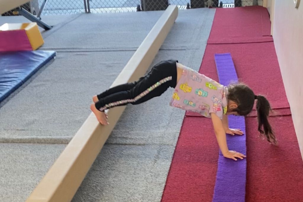 child balancing on beams