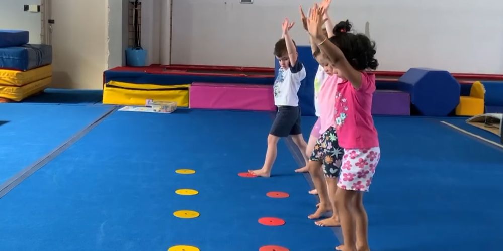 Toddlers practicing somersault